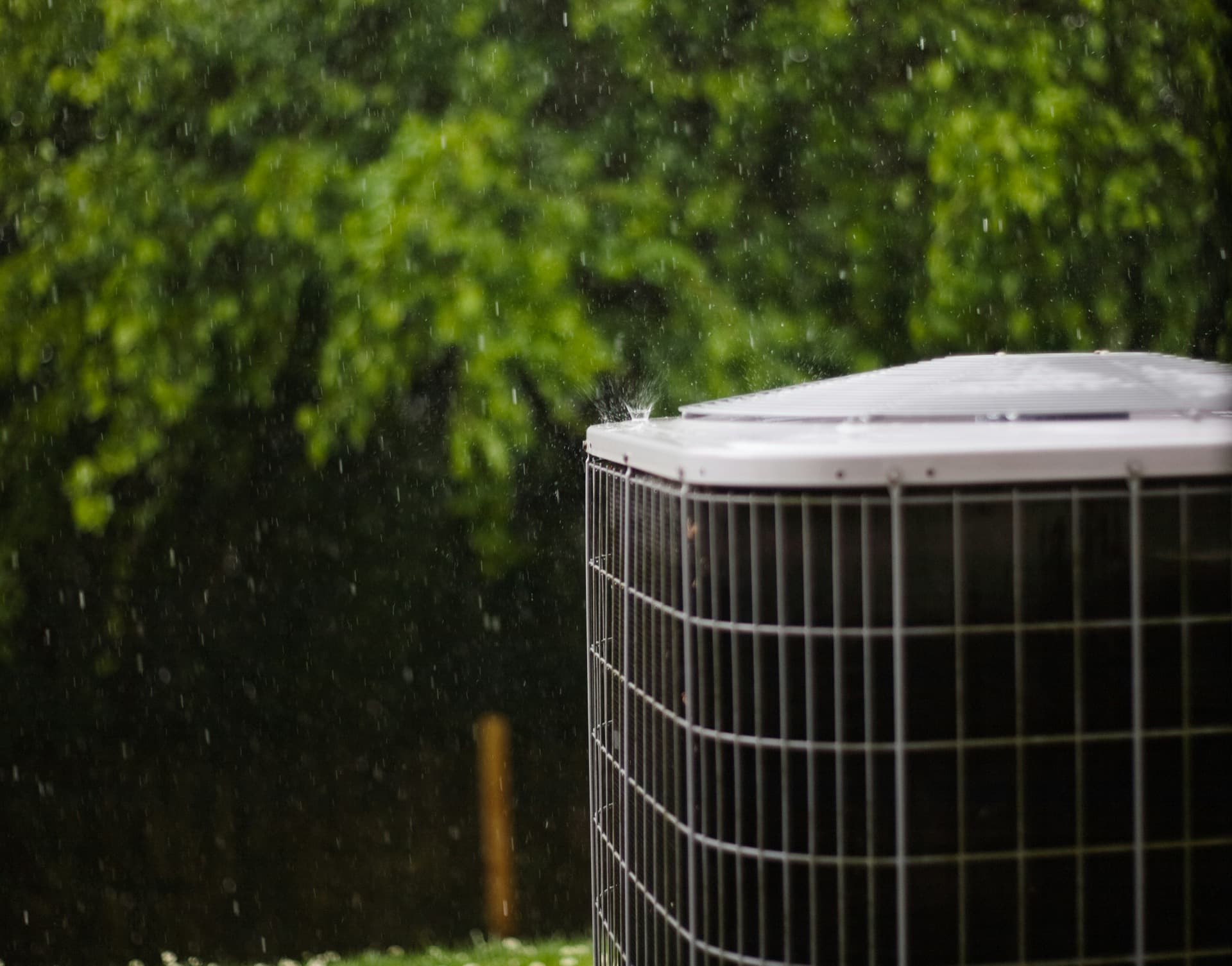 Outdoor condenser unit in the rain during HVAC service.